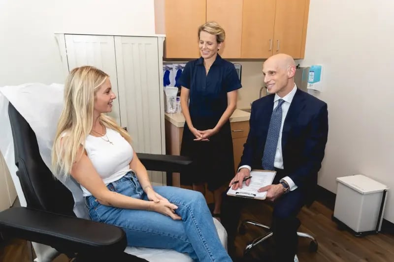 Dr. Dayan smiling while seeing a patient.